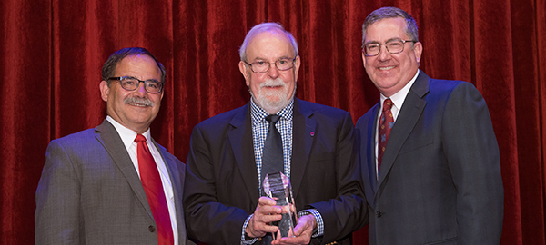 President Schulz and Provost Bernardo congratulate Dr. Kelvin Lynn