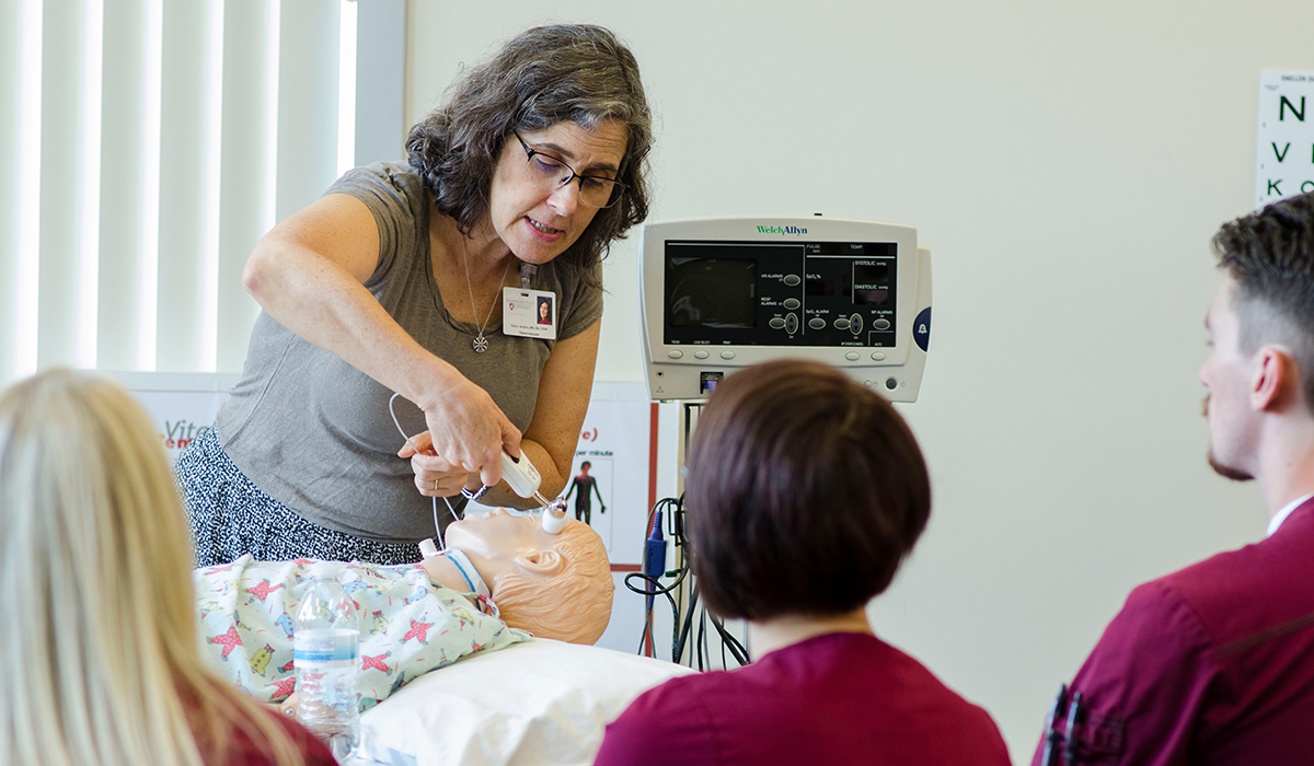 Clinical instructor Karen Anders gives a demonstration to nursing students